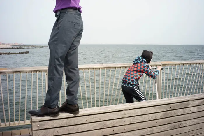 A photo of two people at Steeplechase Pier in Coney Island